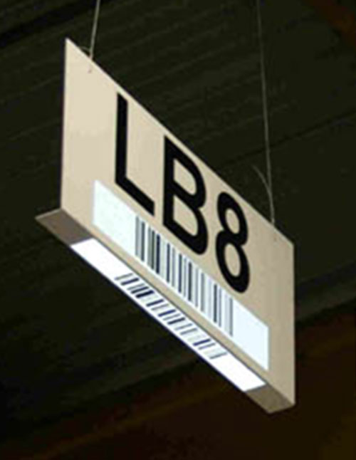 Brown sign hanging from ceiling with label and barcode